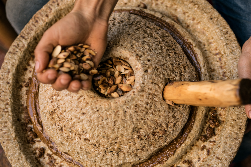 Moroccan craftsman extracts argan oil.